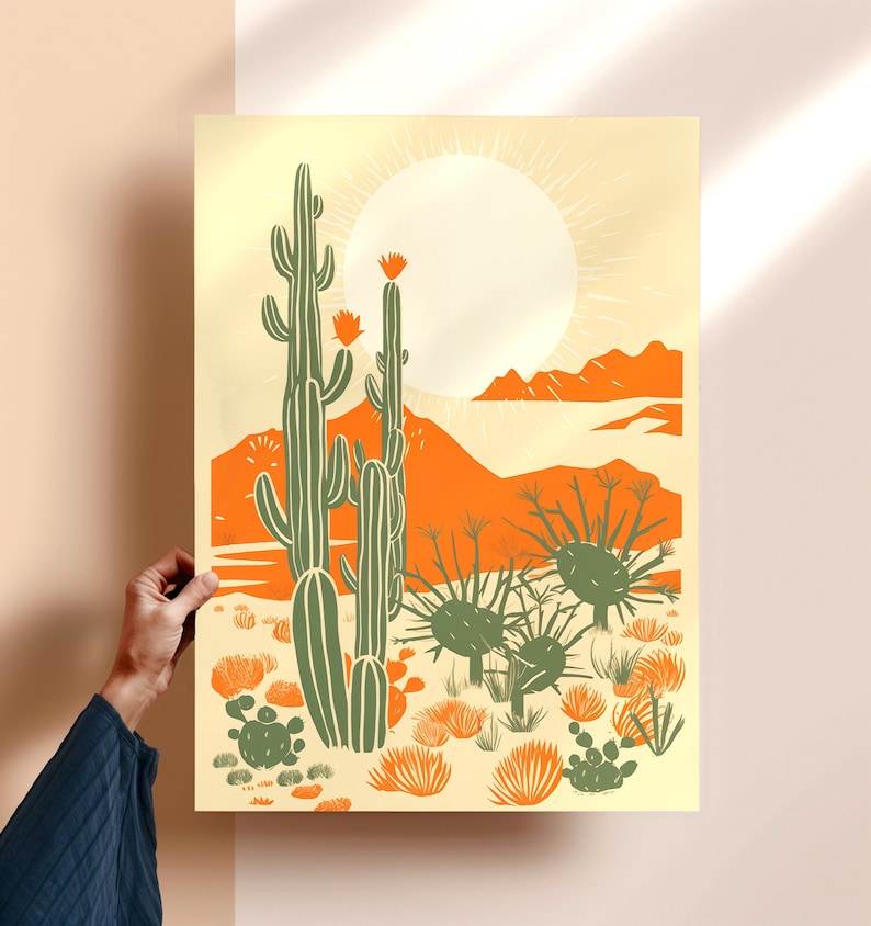 woman holding giclee art print of modern desert cactus, desert poster, linocut cactus art, danish modern aesthetic, beige contemporary art, mid century art, block print cactus, kinfolk magazine, southwest art, cactus poster, orange, sage green