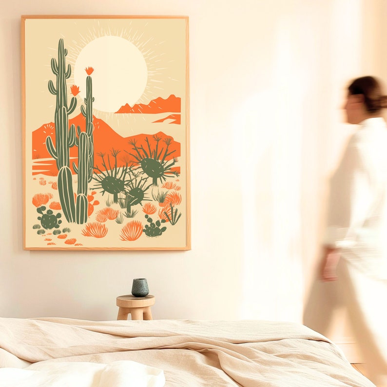 woman with modern desert cactus wall art in large wood frame, desert poster, linocut cactus art, danish modern aesthetic, beige contemporary art, mid century art, block print cactus, kinfolk magazine, southwest art, cactus poster, orange, sage green