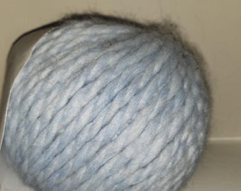 May include: A ball of light blue and white yarn. The yarn is soft and fluffy, and it is perfect for knitting or crocheting.