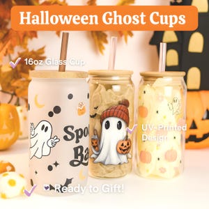 May include: Three 16oz glass cups with bamboo lids and straws, featuring Halloween-themed designs including ghosts, pumpkins, and stars. The text "Halloween Ghost Cups" is at the top, with "16oz Glass Cup," "UV-Printed Design," and "Ready to Gift!" labels.