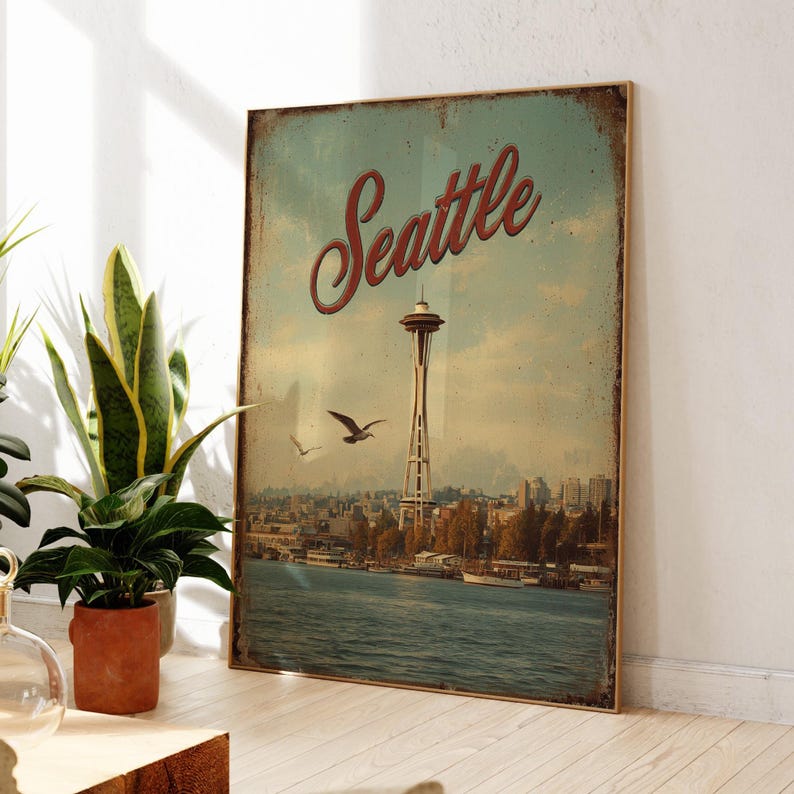May include: A vintage-style poster featuring the Seattle skyline, including the Space Needle, with the city name in red script. The poster has a distressed look, with a blue and tan color scheme, and depicts the waterfront and flying birds.