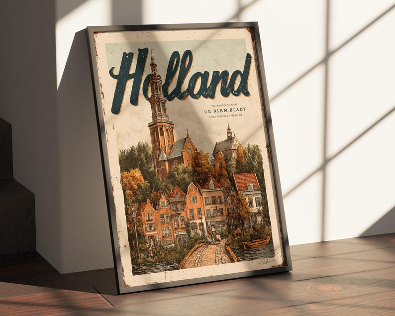 May include: Framed vintage-style print of Holland, featuring a detailed illustration of a Dutch town with a church steeple, colorful houses, and a bridge over a canal. The word "Holland" is in large, stylized letters.