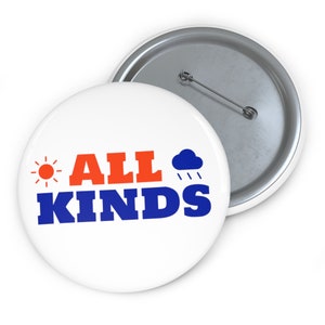 May include: White button with a blue and orange design. The button says "ALL KINDS" with a sun and a cloud with rain.