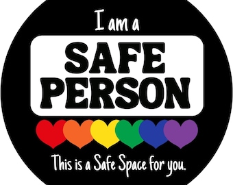 May include: A black and white circle with the text "I am a SAFE PERSON" in a white rectangle. Below the rectangle are six rainbow hearts and the text "This is a Safe Space for you."