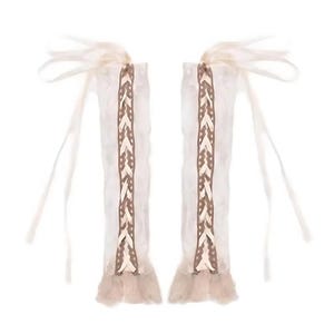 May include: A pair of white lace arm warmers with brown braided trim and long ties.