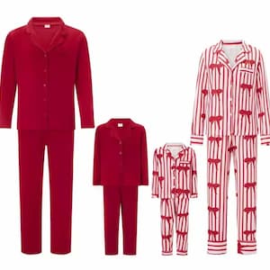 May include: Three sets of matching pajamas. Two sets are solid red, and one set is white with red stripes and red bow accents. Each set includes a button-down top and pants. The pajamas are displayed on a white background.