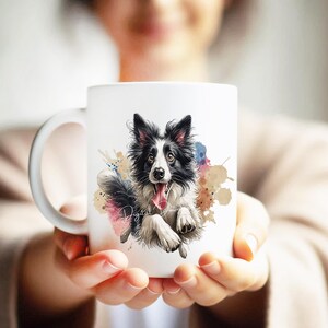 May include: White ceramic mug with a colorful watercolor background featuring a black and white border collie dog with its tongue sticking out. The dog is running and has a happy expression.