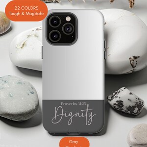 May include: A white and gray phone case with the word "Dignity" in script, and the text "Proverbs 31:25". The case has a gray gradient and is labeled "22 COLORS Tough & MagSafe".