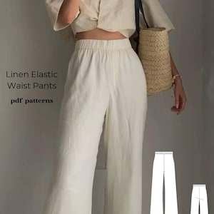 以下が含まれることがあります： 白いリネン素材のパンツで、ウエストはゴム入りです。ワイドレッグでゆったりとしたシルエットです。画像にはパンツのパターンも含まれています。