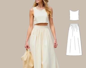 May include: A white crop top and matching maxi skirt. The top has a scoop neck and the skirt has a high waist and pleats.