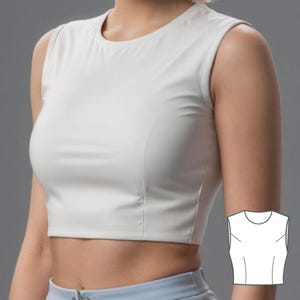 Op de afbeelding: Een wit, mouwloos crop top met een ronde hals. Het topje is strak en heeft een korte lengte. Rechts in de afbeelding is een lijntekening van het topje te zien.