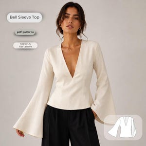 Può includere: Un top color crema a maniche lunghe con un profondo scollo a V e maniche a campana svasate. Il testo sull'immagine recita Bell Sleeve Top, pdf patterns e XXS to 4XL Size Options. Un disegno al tratto bianco del top è visibile in basso a destra.