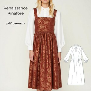 May include: A brown pinafore dress with a gold floral pattern. The dress has a square neckline and a fitted bodice. The skirt is full and gathered at the waist. The dress is shown with a white collared shirt underneath. The image also includes a line drawing of the dress.
