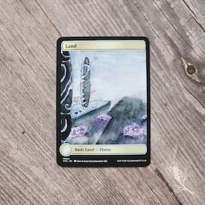 May include: A custom proxy card with the text "Land" at the top. The card features a watercolor landscape with a tall, vertical structure and purple accents. The text "Basic Land - Plains" is at the bottom, along with "NOT FOR TOURNAMENT PLAY".