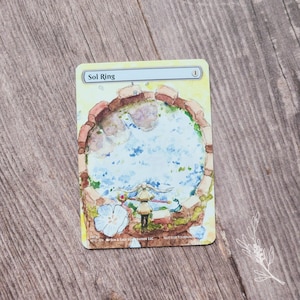 May include: A custom Sol Ring card featuring a watercolor illustration. The card depicts a circular structure with a blue pool of water, a figure, and a white flower. The text "Sol Ring" is at the top.