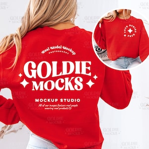 May include: Red long-sleeved sweatshirt with white text that says "GOLDIE MOCKS MOCKUP STUDIO All of our images feature real people wearing real products."