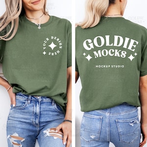 May include: A green t-shirt with short sleeves and a white design on the front that says "Your Design Here" with a star. The back of the shirt has a white design that says "Goldie Mocks" with stars and the text "Mockup Studio".