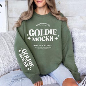 May include: A green sweatshirt with white text that reads "Real POD Mockup Photography Goldie Mocks Mockup Studio All of our images feature real people wearing real products Goldie Mocks".