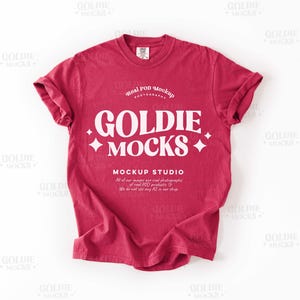 May include: A red t-shirt mockup with the text "GOLDIE MOCKS" in white. The text "Real POD Mockup" and "MOCKUP STUDIO" are also visible on the shirt.