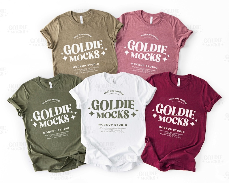 May include: Four t-shirts in different colors, olive green, white, maroon, and heather gray, with the text "Goldie Mocks Mockup Studio" printed on the front.