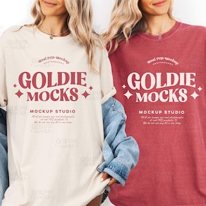 May include: Two women wearing oversized t-shirts. One is cream, the other reddish-pink. Both have "GOLDIE MOCKS" in burgundy, with more text below. The shirts are from a mockup studio. The shirts are part of a mockup studio.