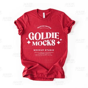 May include: Red t-shirt mockup featuring the text "Goldie Mocks" and "Mockup Studio" in white. The text "Real POD Mockup Photography" is also included.