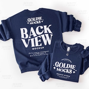 以下が含まれることがあります： 2つのネイビーブルーのスウェットシャツが表示されています。大きいスウェットシャツには白で「BACK VIEW MOCKUP」と書かれています。小さいスウェットシャツには白で「GOLDIE MOCKS MOCKUP STUDIO」と書かれています。どちらも白い背景にあります。