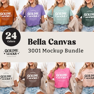 Op de afbeelding: Een mockup-pakket met 24 Bella Canvas 3001 T-shirts in verschillende kleuren. De T-shirts hebben een logo met de tekst "Goldie + Mocks + Mockup Studio".