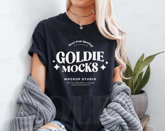 May include: A black t-shirt with a white graphic design that says "Real POD Mockup Photography Goldie Mocks Mockup Studio All of our images feature real people wearing real products".