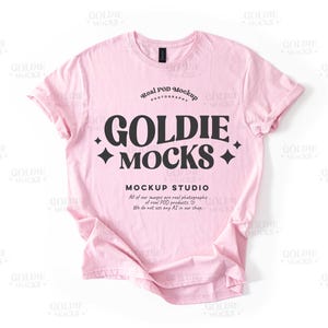 May include: A pink t-shirt mockup with the text "Real POD Mockup Photography" and "Goldie Mocks" in black. The text below reads "Mockup Studio" and "All of our images are real photographic of real POD products. We do not use any AI in our shop."