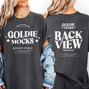 May include: Dark gray t-shirt with the text "GOLDIE MOCKS" in white, with a front and back view. The front of the shirt also says "MOCKUP STUDIO". The back of the shirt says "BACK VIEW MOCKUP".