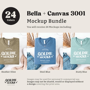 May include: Three folded t-shirts in different colors: heather olive, steel blue, and dusty blue. Each shirt has a white graphic print that says "Goldie Mocks Mockup Studio".