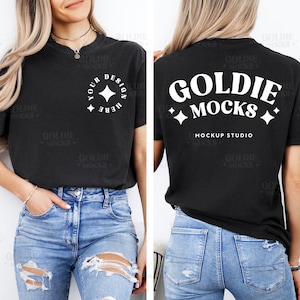 May include: A black t-shirt with a white design on the front that says "Your Design Here" and a white design on the back that says "Goldie Mocks Mockup Studio".
