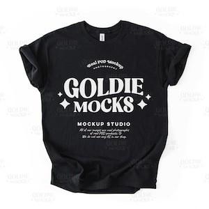 May include: Black t-shirt mockup with white text that reads "Real POD Mockup Photography", "Goldie + Mocks +", and "Mockup Studio". The text also includes the phrase "All of our images are real photographs of real POD products. We do not use any AI in our shop."