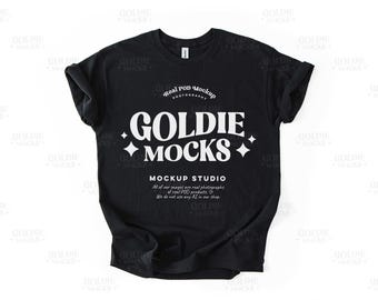 May include: Black t-shirt mockup with white text that reads "Real POD Mockup Photography", "Goldie + Mocks +", and "Mockup Studio". The text also includes the phrase "All of our images are real photographs of real POD products. We do not use any AI in our shop."