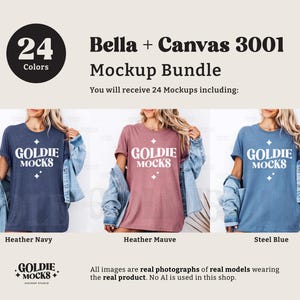 Puede incluir: Tres mujeres vistiendo camisetas de diferentes colores con el texto "Goldie Mocks" impreso en la parte delantera. Las camisetas son azul marino jaspeado, malva jaspeado y azul acero. Las mujeres llevan chaquetas vaqueras y est&aacute;n de pie frente a un fondo de madera.