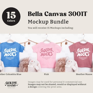 May include: A mockup bundle featuring three Bella Canvas 3001T t-shirts in blue, pink, and mauve, each with the "Goldie Mocks" logo. The image includes the text "15 Colors" and "Mockup Bundle".