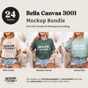 May include: Three women wearing different colored t-shirts with the text "Goldie + Mocks" printed on the front. The t-shirts are in the colors soft cream, heather forest, and dusty blue. The image is a mockup for a t-shirt design.