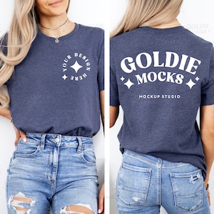 May include: A navy blue t-shirt with short sleeves and a white design on the front that says "Your Design Here" with a star. The back of the shirt has a white design that says "Goldie Mocks Mockup Studio".