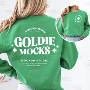 May include: A green sweatshirt with the text "GOLDIE MOCKS" in white. The sweatshirt has a white circle on the back with the text "Real Model Mockup Photography". The sweatshirt also has a white circle on the front with the text "YOUR DESIGN HERE".