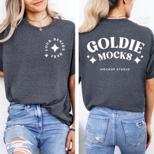 May include: A dark gray t-shirt with a white star design on the front and the text "Goldie Mocks Mockup Studio" on the back.