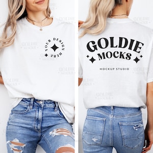May include: A white t-shirt mockup with a black design on the front that says "Your Design Here" in a circle with a star. The back of the shirt has a black design that says "Goldie Mocks Mockup Studio" with stars on either side. The model is wearing blue jeans.