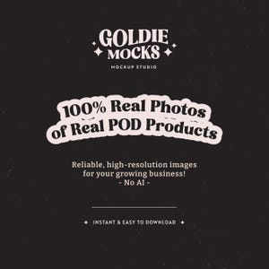 May include: A black and white graphic with the text "GOLDIE MOCKS" in a retro font. The text "MOCKUP STUDIO" is below the main text. The graphic also includes the text "100% Real Photos of Real POD Products" in a white circle with a black outline. The text "Reliable, high-resolution images for your growing business! - No AI -" is below the circle. The text "INSTANT & EASY TO DOWNLOAD" is at the bottom of the graphic.