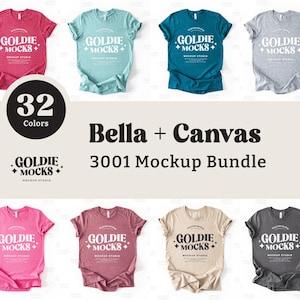 May include: A mockup bundle of 32 Bella + Canvas 3001 t-shirts in various colours. The t-shirts are laid flat on a white background. The text "GOLDIE + MOCKS +" is printed on each shirt.