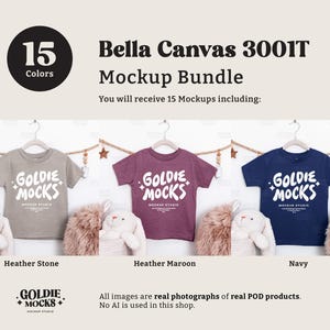 May include: A mockup bundle featuring three Bella Canvas 3001T t-shirts in Heather Stone, Heather Maroon, and Navy. Each shirt displays the "GOLDIE MOCKS" logo in white. The image includes text indicating 15 colors are available.