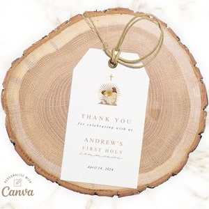 May include: White thank you tag with gold text and a watercolor illustration of a religious scene. The text reads "Thank you for celebrating with us Andrew's First Holy Communion April 14, 2024".