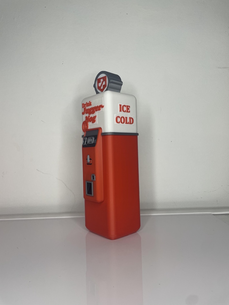 May include: Red and white vintage-style drink dispenser with the text "Drink Jugger-Nog" and "ICE COLD".