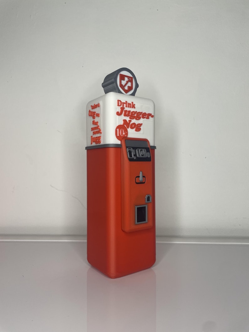 May include: A red and white vintage-style vending machine with the text "Drink Jugger-Nog 10&cent;" on the front. The machine has a coin slot and a button.