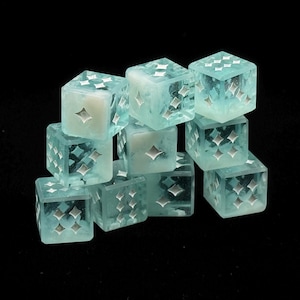 May include: A collection of translucent, light blue dice with silver starburst patterns. The dice are stacked against a black background, showcasing their intricate designs and clear, icy appearance. These dice are perfect for tabletop games.