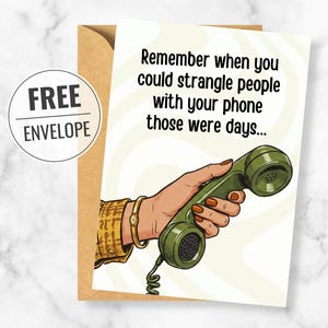 May include: A greeting card featuring an illustration of a hand holding a vintage olive green telephone handset with a coiled cord. The text reads, Remember when you could strangle people with your phone those were days... A brown envelope is included.